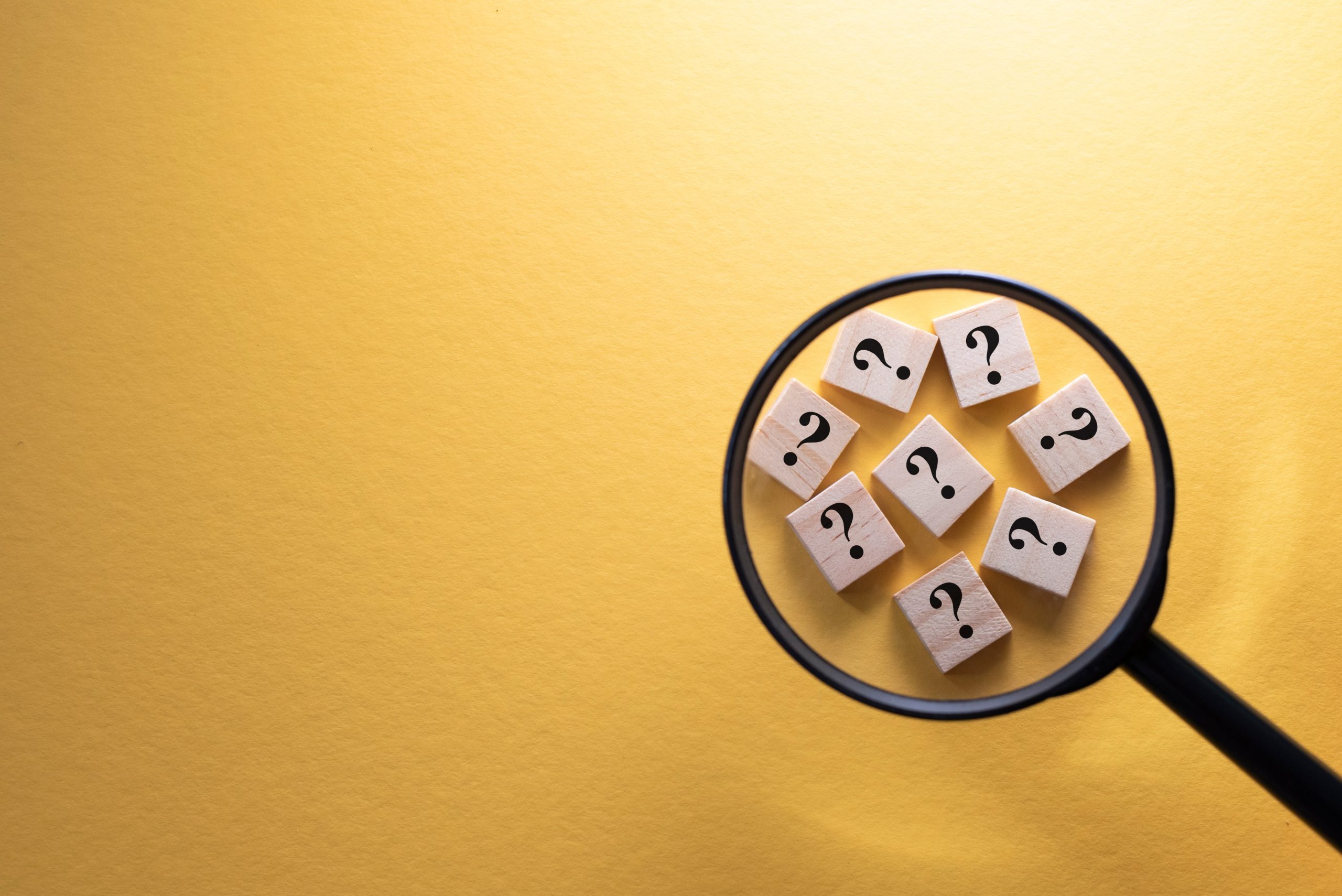 focus question mark symbol wooden tiles using magnifying glass